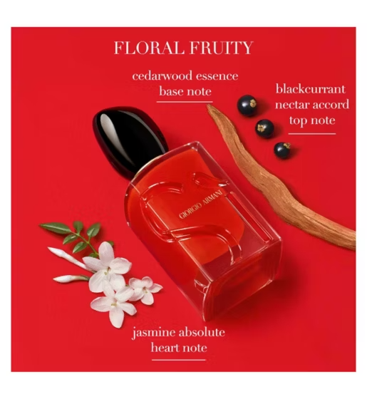 Red perfume bottle with floral and fruit elements on a red background