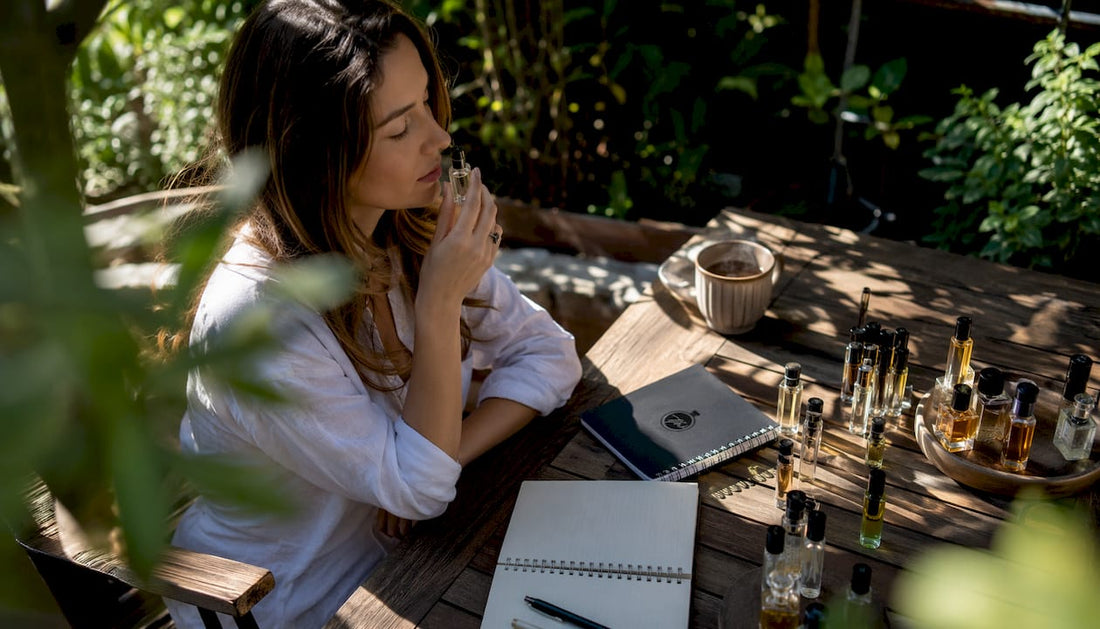 Woman smelling perfume vial in cozy kitchen