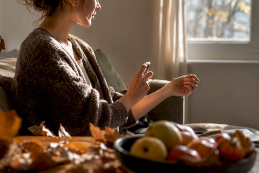 Person spraying perfume sample on wrist