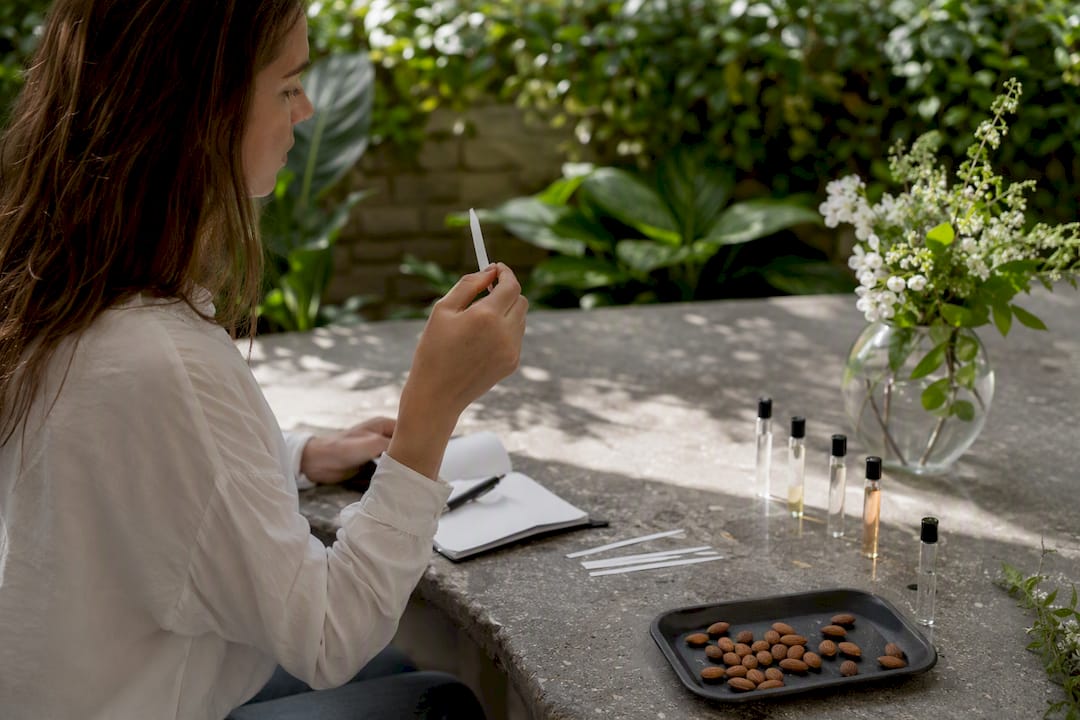 Hand sampling almond fragrance with blotter