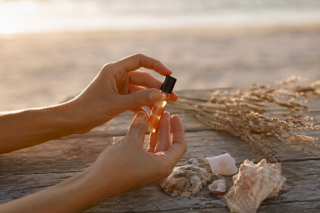 Hand holding ambergris perfume decant vial