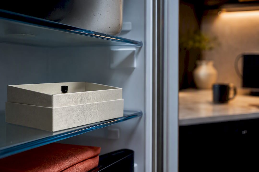 Anonymous fragrance vial inside refrigerator storage box