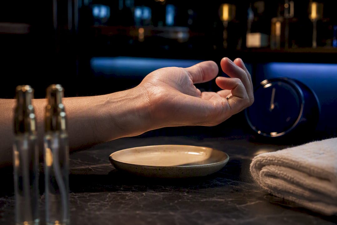 Anonymous fragrance decants beside tested wrist
