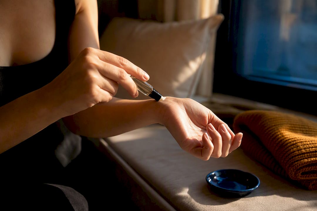 Person testing fragrance sample on wrist