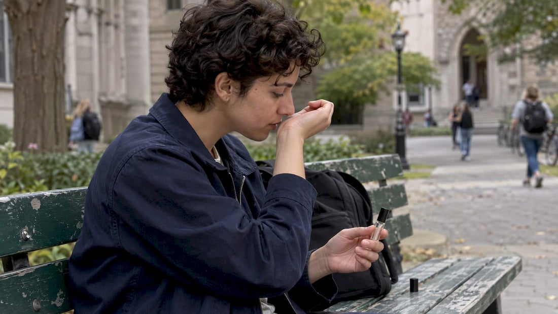 Student testing a fragrance decant on wrist