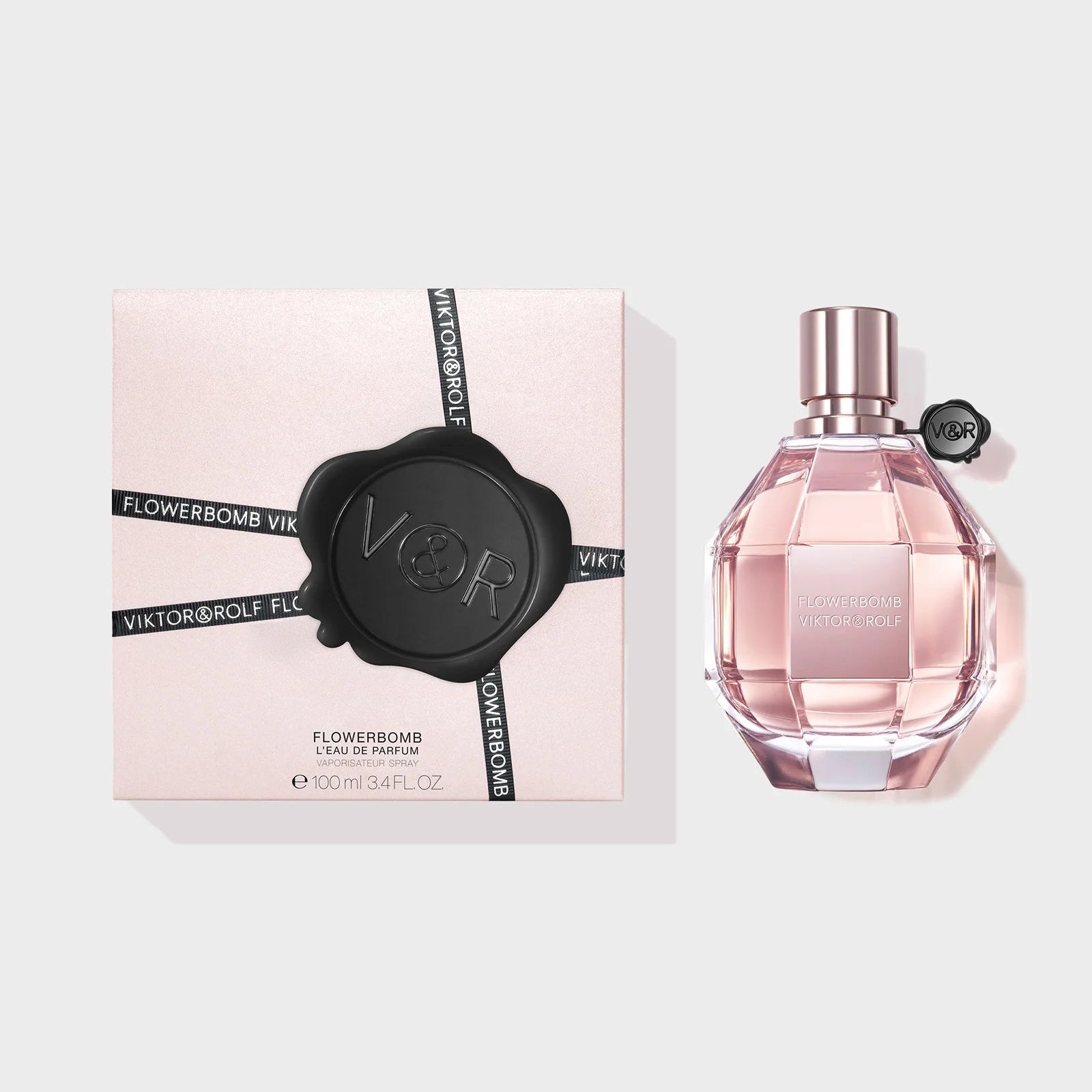 Victor & Rolf Flowerbomb perfume bottle and packaging on a light gray background