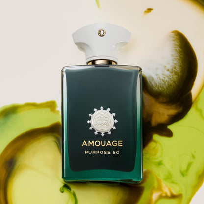 Amouage Purpose 50 perfume bottle in a dark green glass bottle with a white cap, set against a background of green and yellow liquid swirls.