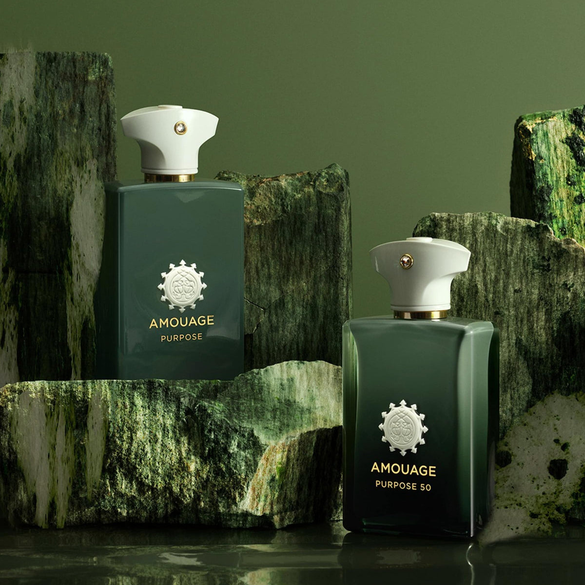 Two Amouage Purpose 50 perfume bottles on a textured green background