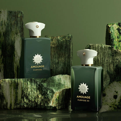 Two Amouage Purpose 50 perfume bottles on a textured green background