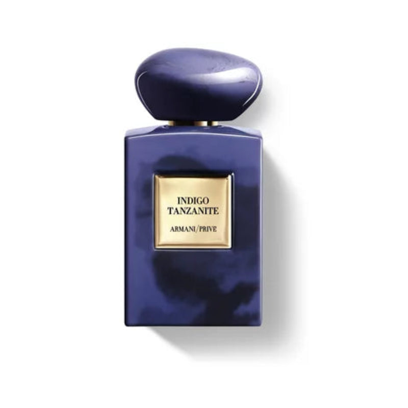 Blue perfume bottle with gold cap and label on a white background