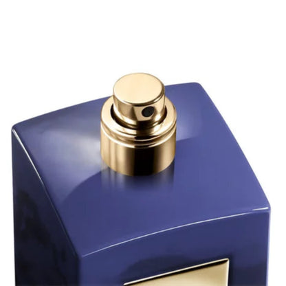Blue perfume bottle with gold cap on a white background