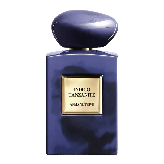 Blue perfume bottle with gold label on a white background. Armani Privé Indigo Tanzanite Eau de Parfum