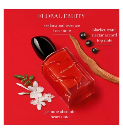Red perfume bottle with floral and fruit elements on a red background