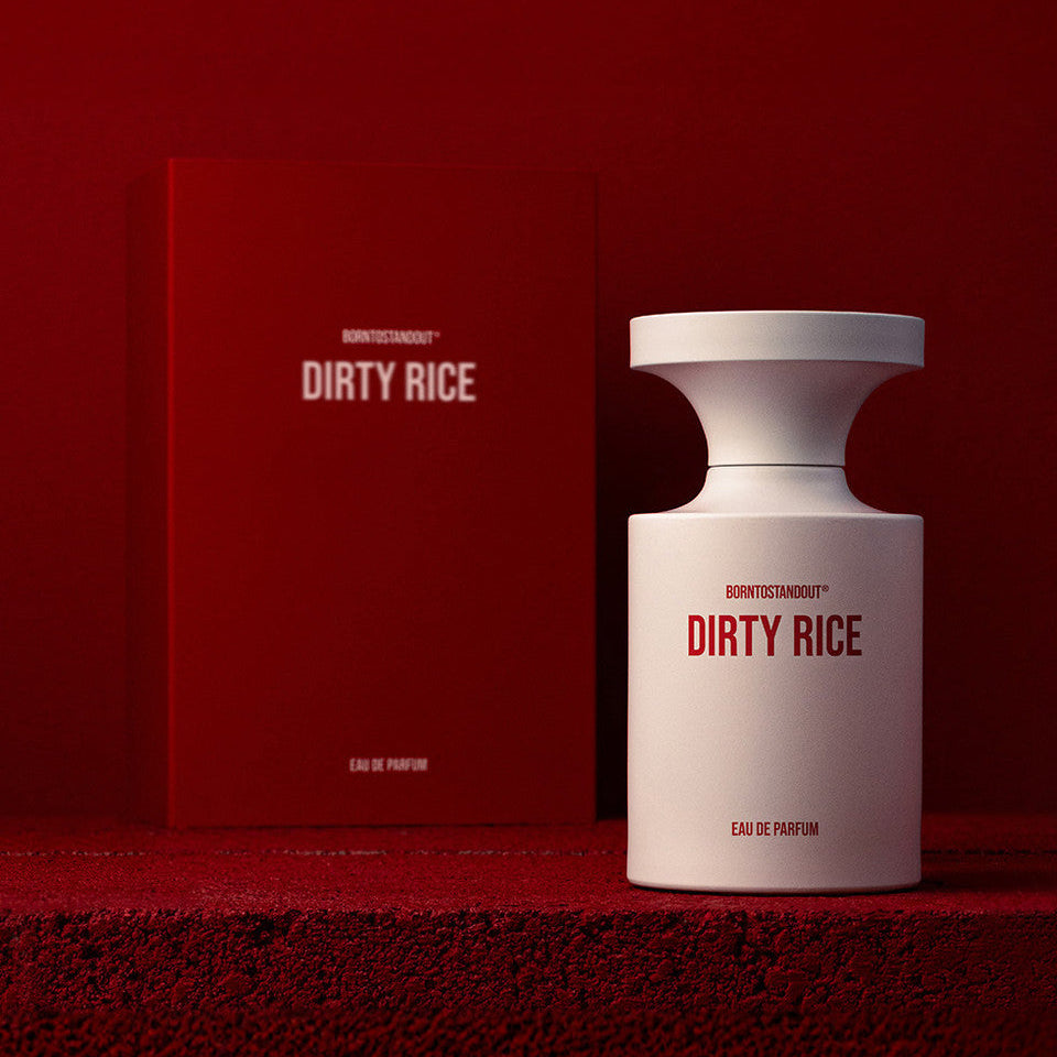 Perfume bottle and packaging of 'DIRTY RICE' on a red background