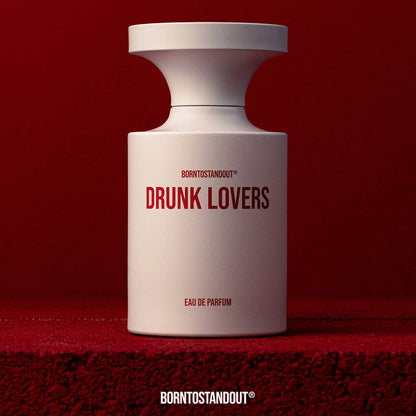 White perfume bottle labeled 'Drunk Lovers' on a red background with text above and below.
