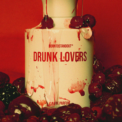 Perfume bottle labeled 'Drunk Lovers' with cherries and red background