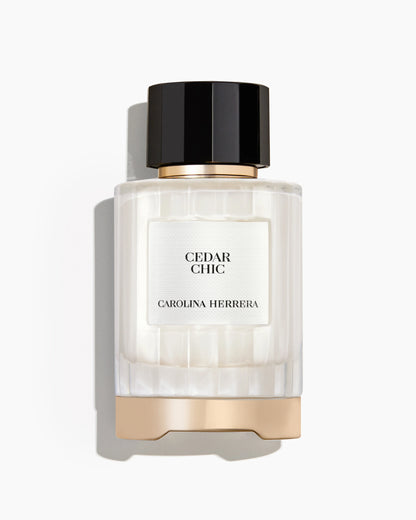 Perfume bottle labeled 'Cedar Chic' by Carolina Herrera on a white background