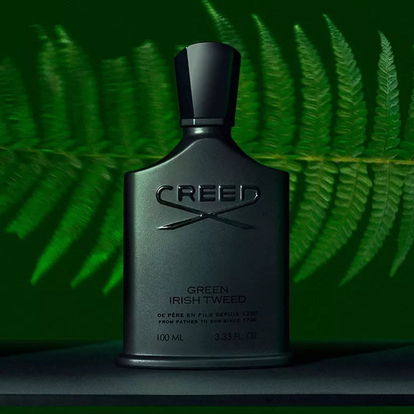 Creed Green Irish Tweed perfume bottle against a green leafy background