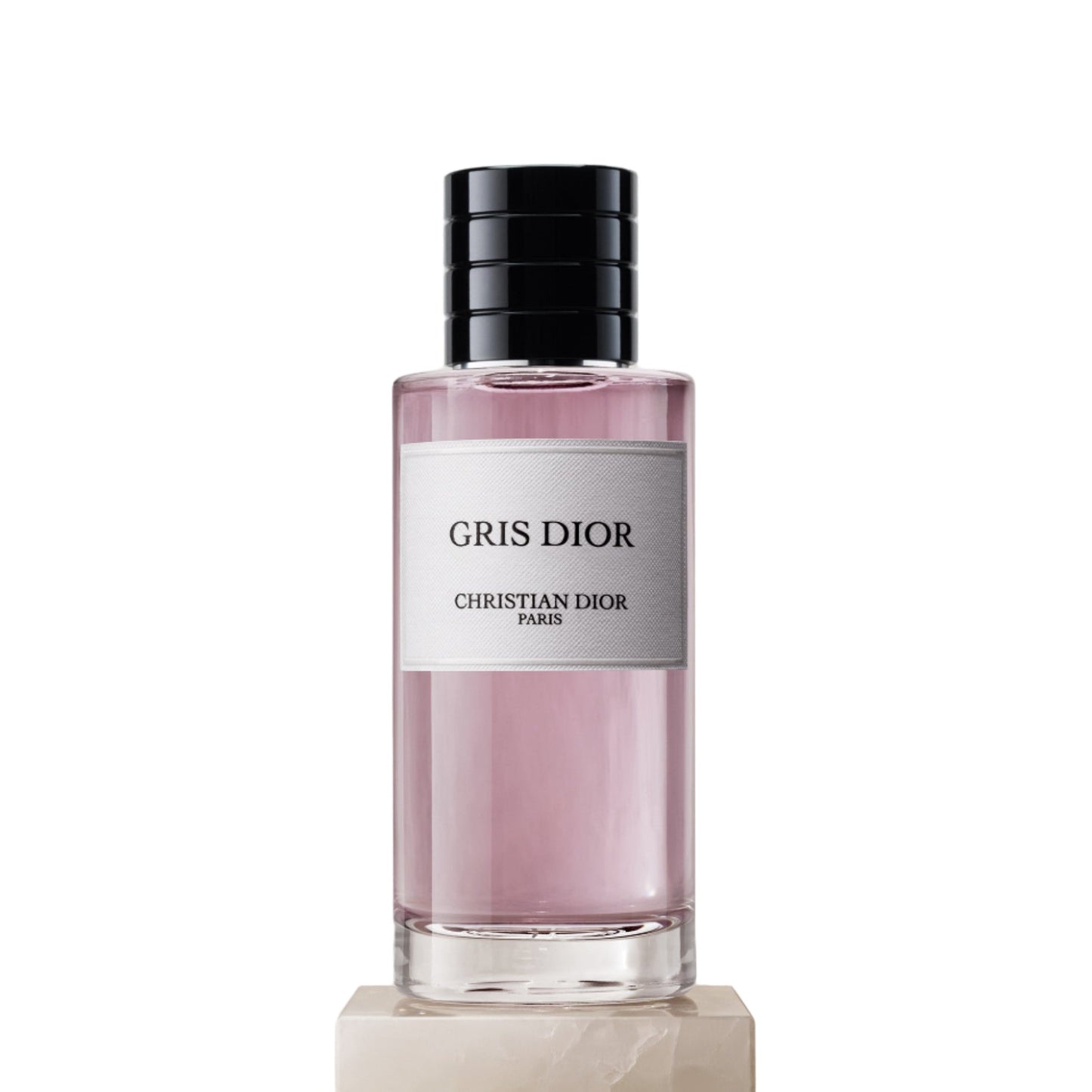 Gris Dior perfume bottle on a beige pedestal with a light background