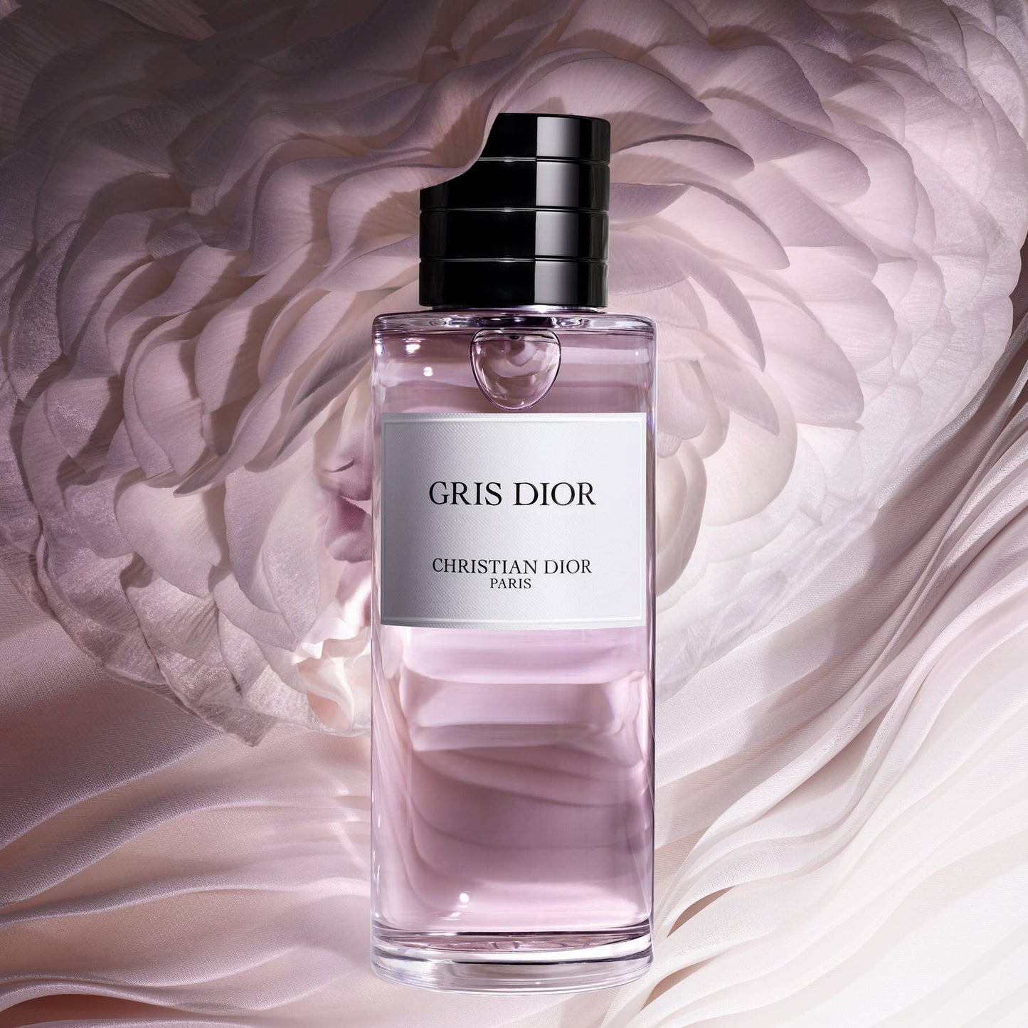 Gris Dior perfume bottle with a soft pink background