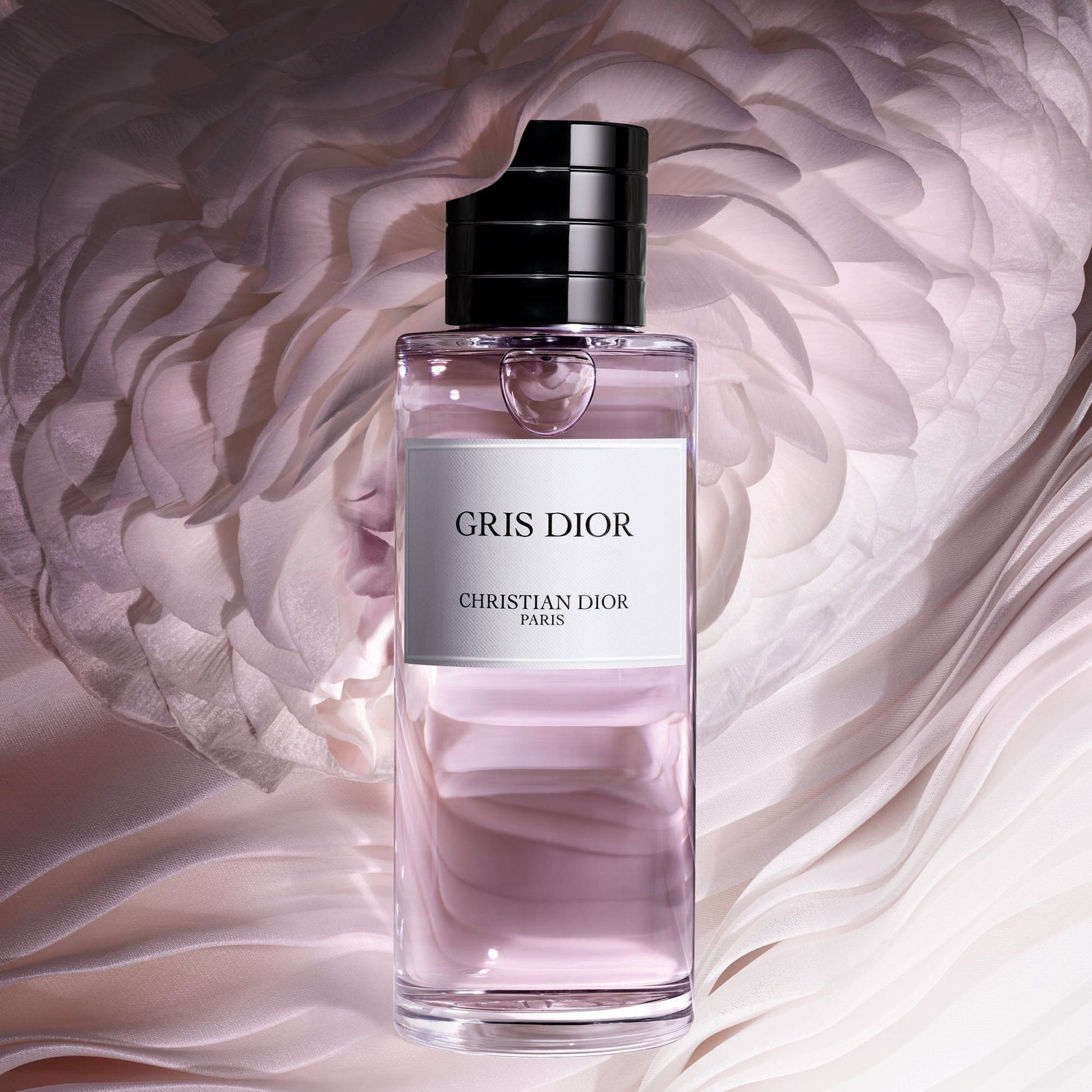 Gris Dior perfume bottle with a soft pink background