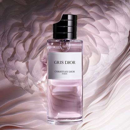Gris Dior perfume bottle with a soft pink background