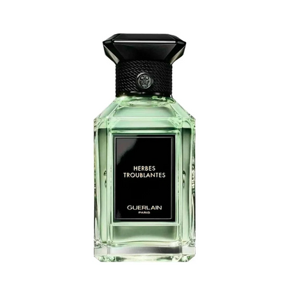 Guerlain perfume bottle with black cap on a white background