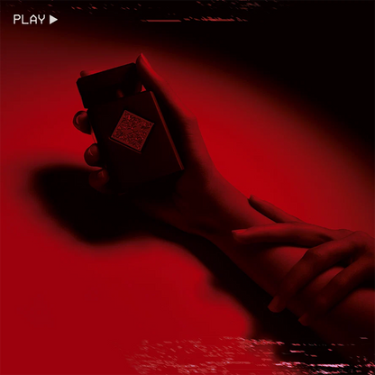 Hand holding a small rectangular object against a red background