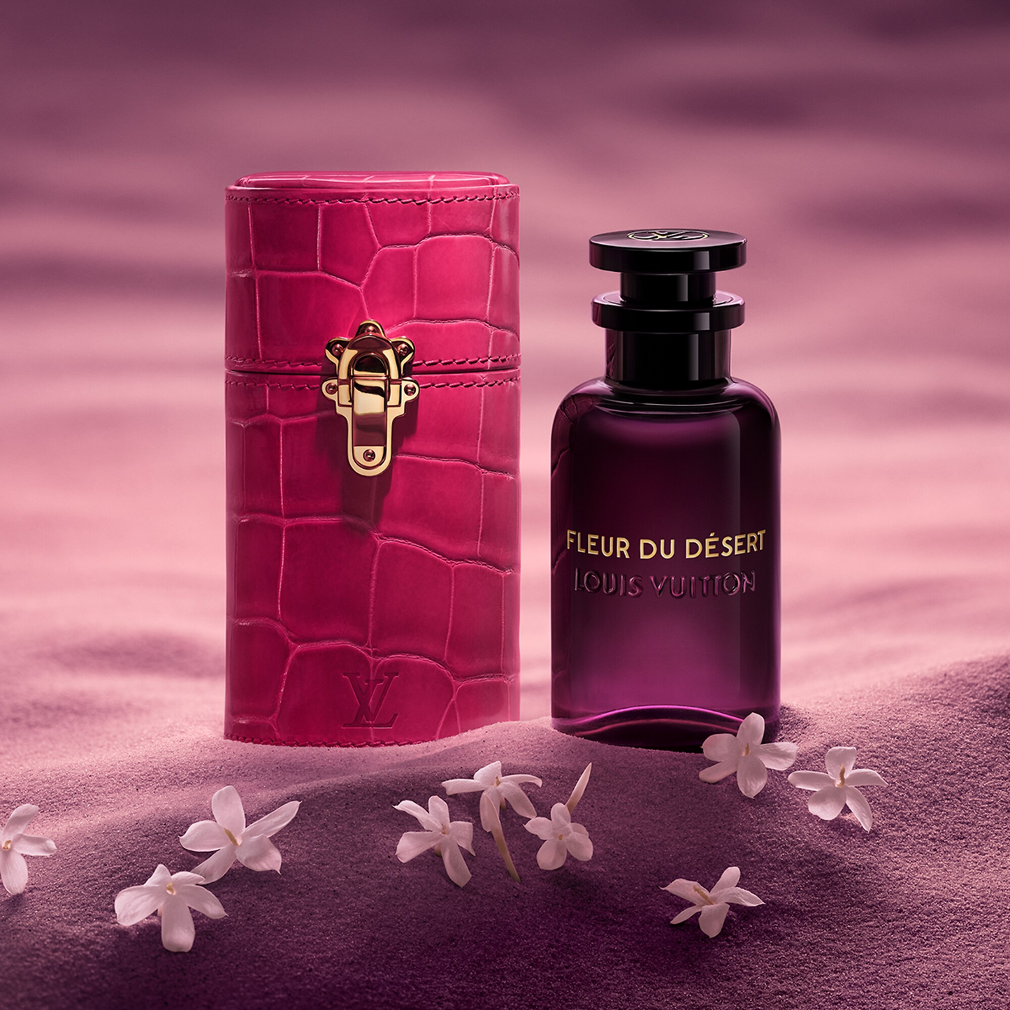 Louis Vuitton perfume bottle and pink crocodile-textured case on a purple background with flowers.