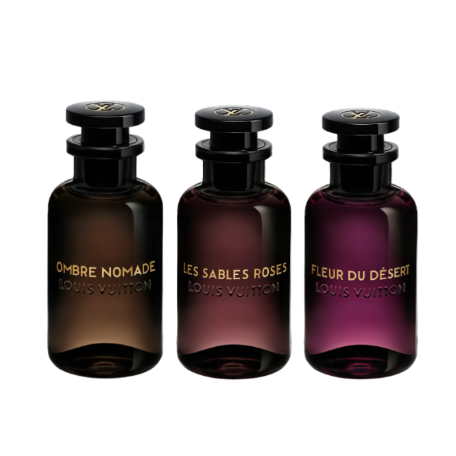 Three dark glass perfume bottles with gold labels on a white background