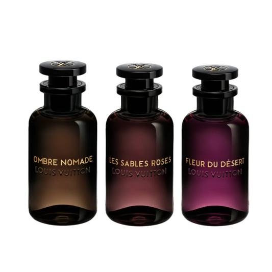 Three dark glass perfume bottles with gold labels on a white background