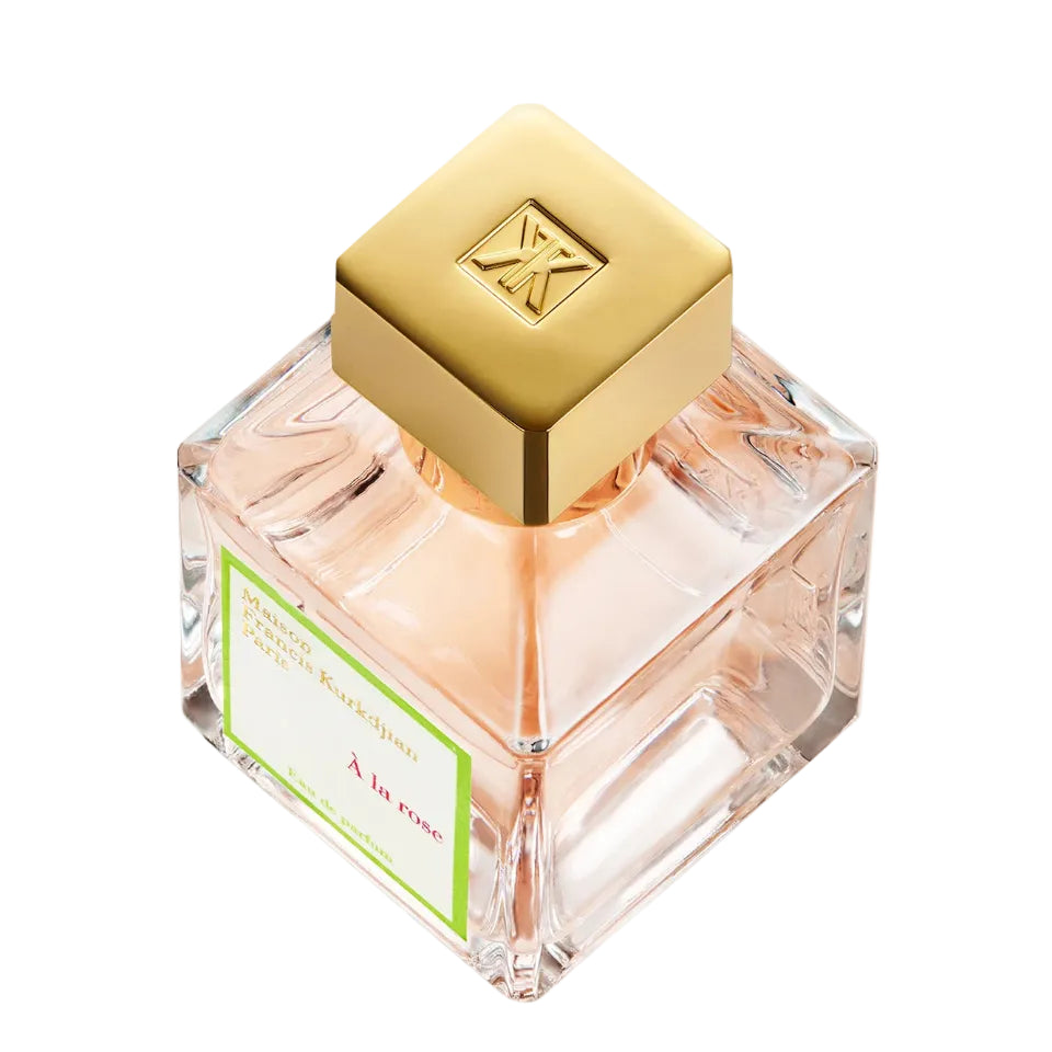 Perfume bottle with gold cap and clear glass body on a white background