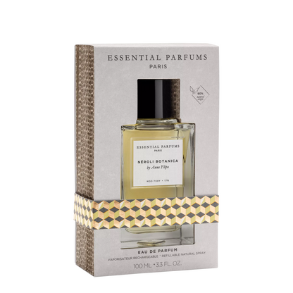 Essential Parfums Paris Neroli Botanica & Citron Eau de Parfum in a 100ml box, featuring a clear glass bottle with a black cap and a light yellow liquid, wrapped in a patterned ribbon against a light gray background.