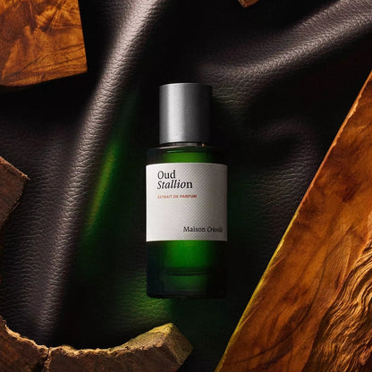 Green bottle with a white label on a dark surface with wooden elements