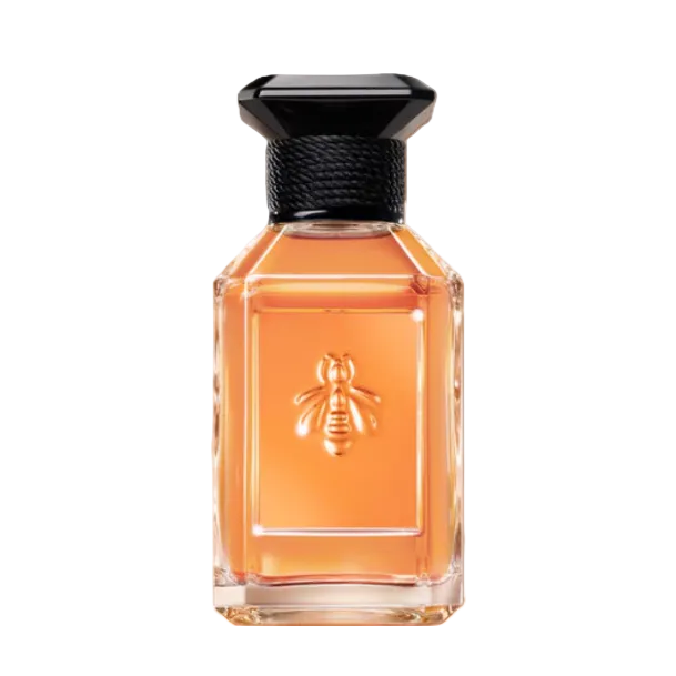 A rectangular glass perfume bottle filled with amber-orange liquid, featuring an embossed bee on the front and a black faceted cap, isolated on a white background.