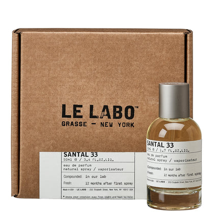 Le Labo Santal 33 perfume bottle with packaging on a white background