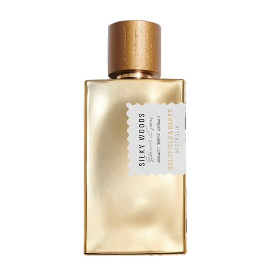 Gold perfume bottle with wooden cap on a white background