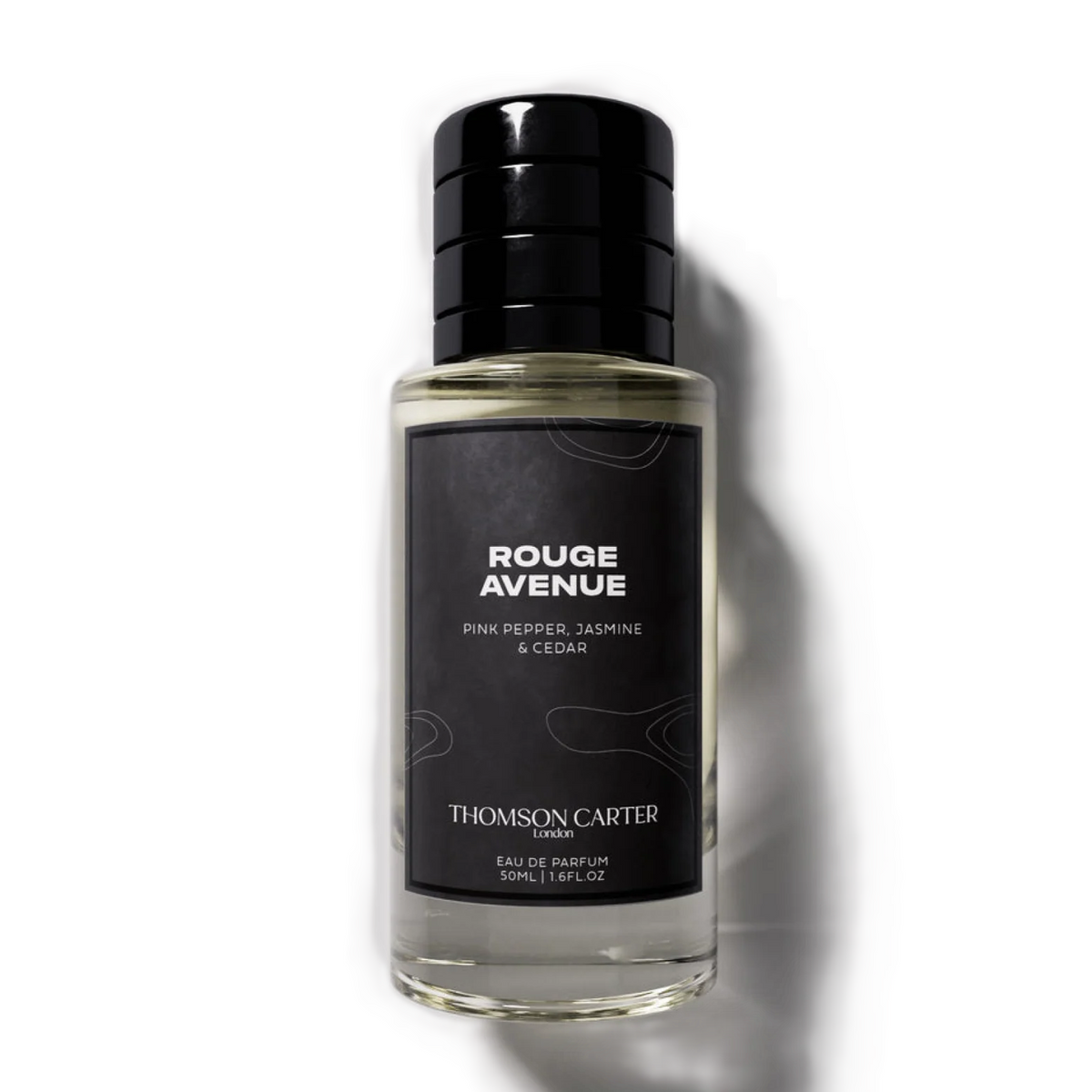 A bottle of Thomsom Carter Rouge Avenue Eau de Parfum, featuring a black cap and a black label with white text, set against a clean white background with a soft shadow.