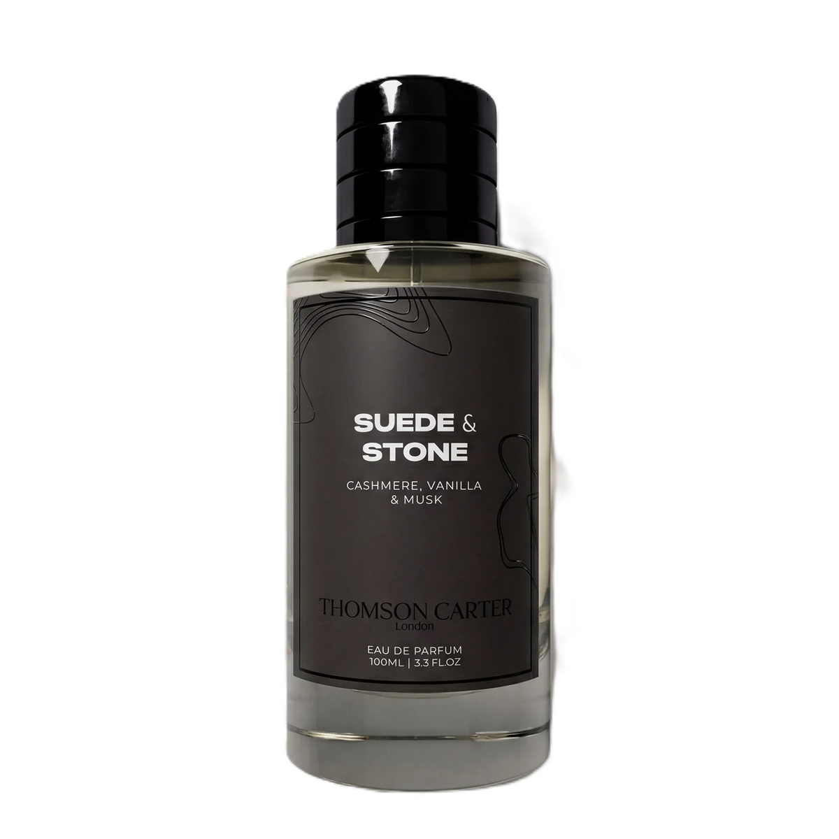 A bottle of Thomson Carter Suede & Stone Eau de Parfum, featuring a dark charcoal gray label with white text and a black cap, set against a plain white background.