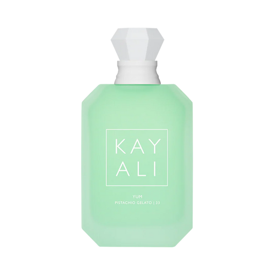 Green perfume bottle with white cap on a white background