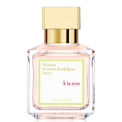 A glass perfume bottle with a gold cap, labeled À la rose by Maison Francis Kurkdjian.